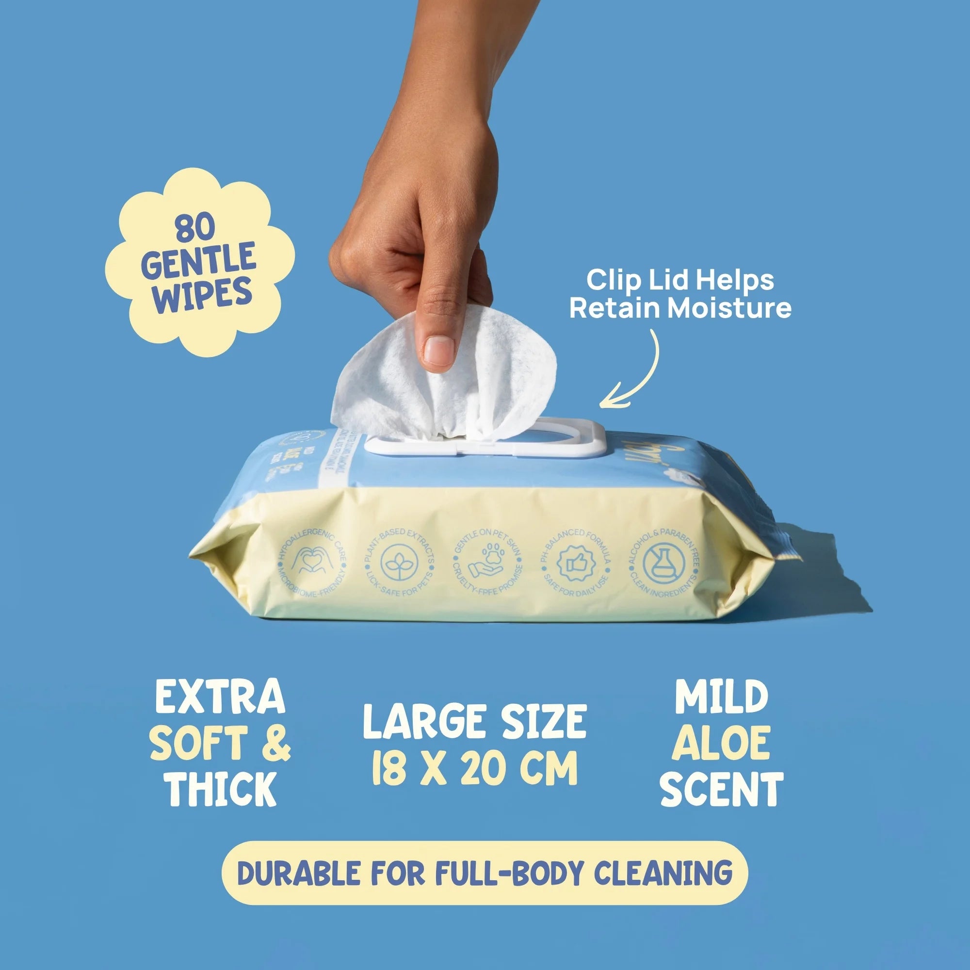 Hand holding a wipe above a package of wipes with text highlighting features on a blue background. Large 18x20cm pet wipes with clip lid for moisture retention, extra-soft and thick for gentle grooming.